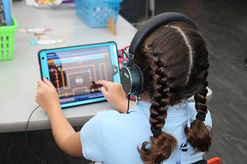 A second grader works on an assignment during classes at St. Bonaventure School in Davie using her iPad.