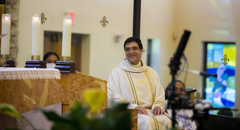 Msgr. Michael Souckar, pastor at St. Andrew Church in Coral Springs, smiles during Archbishop Thomas Wenski's homily at the parish's 50th anniversary Mass, Nov. 1, 2020.