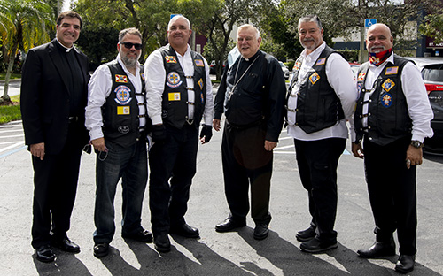 Middle, Archbishop Thomas Wenski and left, Msgr. Michael Souckar, pastor at St. Andrew Church in Coral Springs, stand next to members of the Knights of Columbus Knights on Bikes after the parish's 50th anniversary Mass, Nov. 1, 2020.