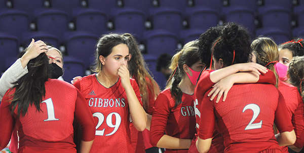 Cardinal Gibbons players, including Valeria Lozada (1), Emma O'Keeffe (29) and Dylan Andrews (2), console each other after their loss to Bishop Kenny in the FHSAA Class 4A volleyball state final match Nov. 15, 2020 2020 at Suncoast Credit Union Arena in Fort Myers. Bishop Kenny defeated Cardinal Gibbons 29-27, 25-18, 17-25, 25-20 to win their third state title.