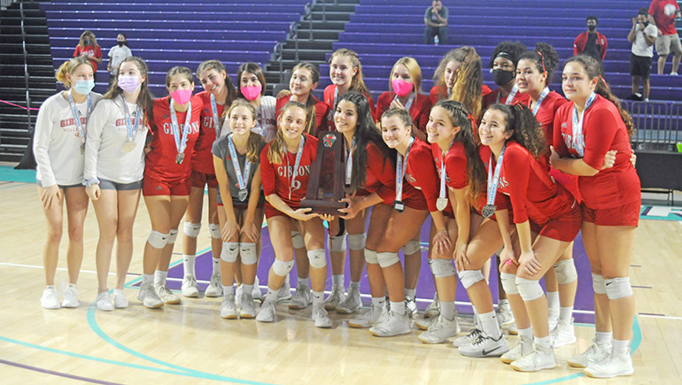 Cardinal Gibbons players pose for a team photo after the FHSAA Class 4A volleyball state final match Nov. 15, 2020 at Suncoast Credit Union Arena in Fort Myers. Bishop Kenny defeated Cardinal Gibbons 29-27, 25-18, 17-25, 25-20 to win their third state title.