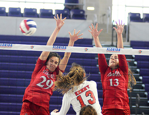 Cardinal Gibbons blockers Emma O'Keeffe (29) and Jessica Cinci (13) block Bishop Kenny's Ashton Dilts during their FHSAA Class 4A volleyball state final match Nov. 15, 2020 at Suncoast Credit Union Arena in Fort Myers. O'Keeffe had five blocks, and Cinci had four blocks. Bishop Kenny defeated Cardinal Gibbons 29-27, 25-18, 17-25, 25-20 to win their third state title.