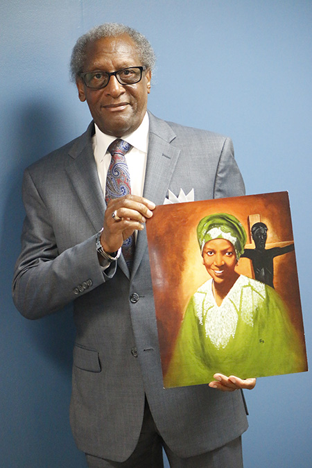 Donald Edwards, associate superintendent of schools for the Archdiocese of Miami, poses with an image of his good friend, now Servant of God Sister Thea Bowman.