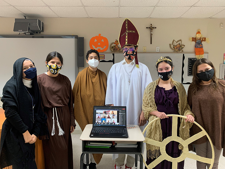 Eighth graders from Mother of Our Redeemer School show off their saint costumes to mark the feast of All Saints, as their classmates learning from home also take part. The display took place Nov. 2, 2020.