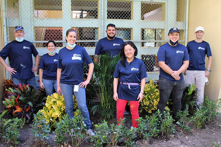 Volunteers from Hancock, Askew and Co. pose in the garden they helped plant at Catholic Charities of the Archdiocese of Miami's Notre Dame Child Development Center in Little Haiti, Nov. 5, 2020. From left are Craig Armstrong, Solanghe Rodriguez, Vanessa Barrera, Anthony Perez-Florido, Adriana Kambe, Adrian Fresnedo and Javier Serpa. The accountants and auditors at Hancock, Askew and Co. participate twice a year in community service projects across the state. In addition to planting a garden, they also cleaned and painted part of the entrance wall, and the playground.