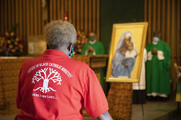 Katrenia Reeves-Jackman, director of the Office of Black Catholic Ministry, prays during the Mass commemorating the feast day of St. Martin de Porres, Nov. 8, 2020. The Mass took place at St. Augustine Church in Coral Gables, and marked the start of Black Catholic History Month.