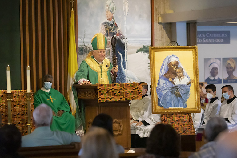 Archbishop Thomas Wenski preaches the homily during the Mass celebrating the feast day of St. Martin de Porres, Nov. 8, 2020. The Mass took place at St. Augustine Church in Coral Gables, and marked the start of Black Catholic History Month. Next to the archbishop is an image of the Black Madonna with child.