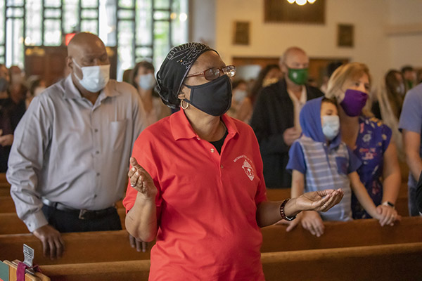 Joselyn Brown is among the socially distanced faithful gathered at St. Augustine Church in Coral Gables to attend the Mass commemorating the feast day of St. Martin de Porres, Nov. 8, 2020. The Mass marked the start of Black Catholic History Month and was hosted by the Archdiocese of Miami's Office of Black Catholic Ministry.