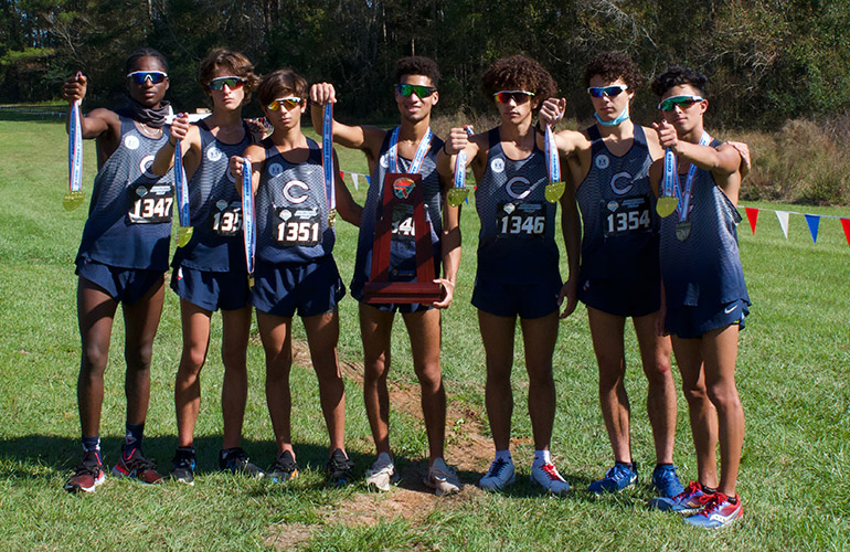 Christopher Columbus High School's cross country team show off their gold medals after winning their fifth state championship, Nov. 14, 2020 in Tallahassee. The team played with DQ emblems on their uniforms in memory of Danny Quesada, a Columbus cross country runner who died in 2019 at the age of 18 after a long battle with cystic fibrosis.