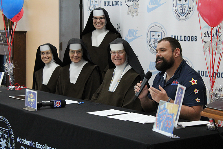 Luis Perez, TV production and broadcasting teacher at Archbishop Coleman Carroll High, and the announcer for the Harlem Globetrotters in Miami, announces the 2020 Harlem Globetrotters Player Draft honorary member: Sister Margaret Ann. She accepted on behalf of her fellow Carmelite Sisters of the Most Sacred Heart of Los Angeles who work at the school: Sister Ines, Sister Immaculata, Sister Mara, and Sister Mary Elizabeth (not pictured).