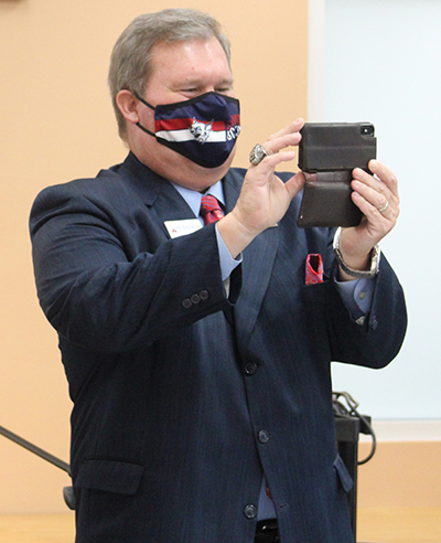 St. Thomas University president David Armstrong captures the Harlem Globetrotters letter-signing moment, Nov. 16, 2020.