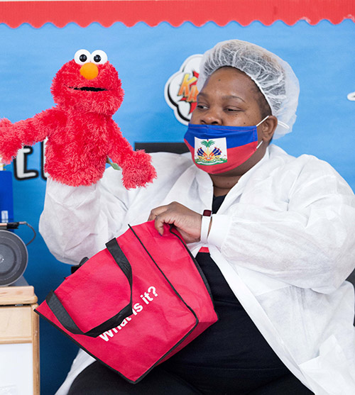 A staff person teaches while wearing personal protective gear at the Head Start and Early Head Start program at Holy Redeemer Church in Miami, one of six such programs throughout Miami-Dade County operating at reduced in-class capacity during the COVID-19 global pandemic.