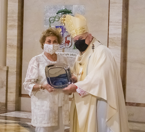 Archbishop Thomas Wenski gives Sandy McCarthy the One in Charity award during the Thanks-for-Giving Mass celebrated at St. Mary Cathedral, Nov. 21, 2020.