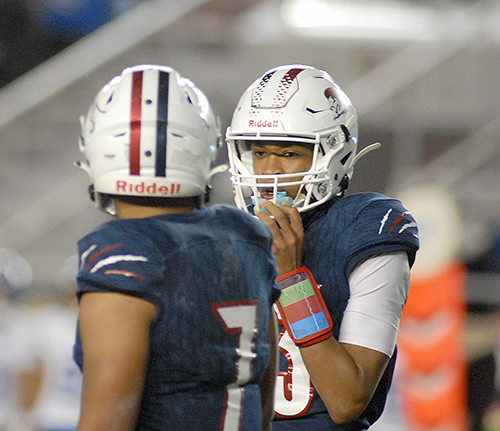 Chaminade-Madonna quarterback Jaylon Tolbert, right, and running back Davion Gause discuss a play call during the first half of Chaminade-Madonna's 25-22 loss to Jacksonville Trinity Christian, Dec. 16, 2020, in the Class 3A Football Final at Bobby Bowden Field at Doak Campbell Stadium in Tallahassee.