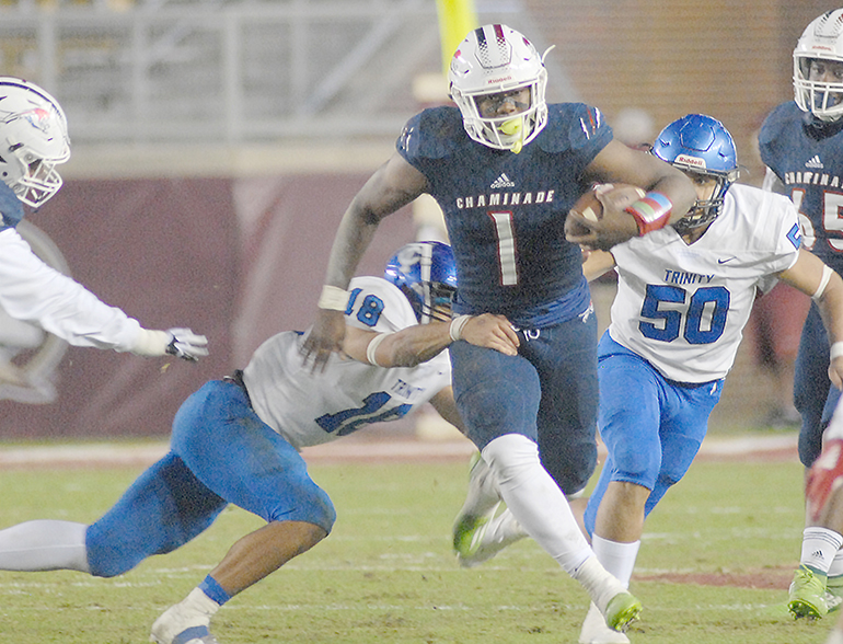 Chaminade-Madonna running back Thaddius Franklin (1) tries to break the tackle of Trinity Christian's Thomas Fryer (18) as Jonathan Goddard (50) gives chase during the second half of Chaminade-Madonna's 25-22 loss to Trinity Christian, Dec. 16, 2020, in the Class 3A FHSAA Football Championship Game at Bobby Bowden Field at Doak Campbell Stadium in Tallahassee.