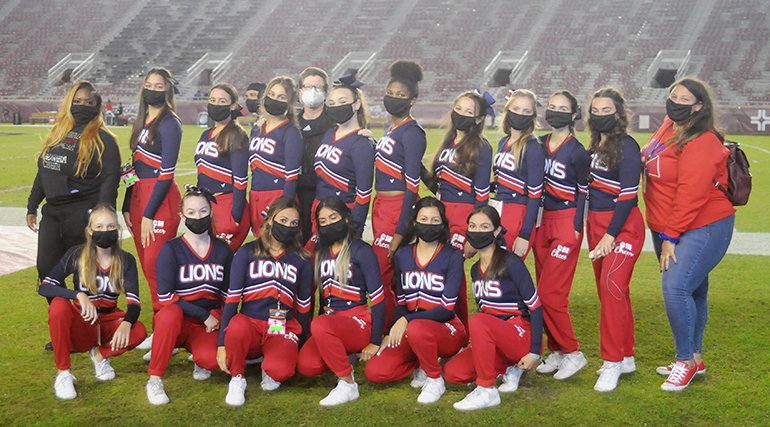 Chaminade-Madonna cheerleaders and their coaches pose for a photo during the first half of the Lions' 25-22 loss to Jacksonville Trinity Christian, Dec. 16, 2020, in the Class 3A Football Final at Bobby Bowden Field at Doak Campbell Stadium in Tallahassee.