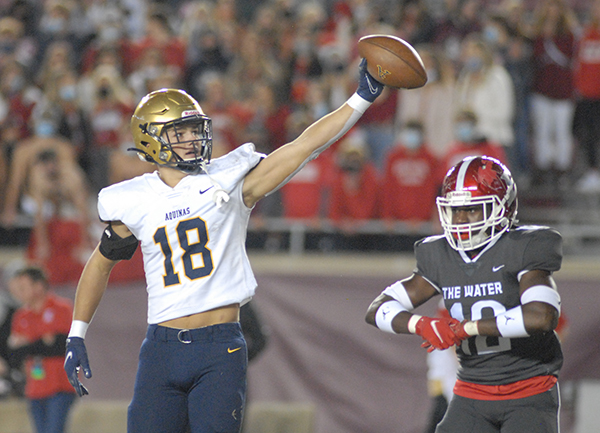 St. Thomas Aquinas receiver Mason Taylor signals a first down after being tackled by Edgewater's Christopher Fulse during the first half of St. Thomas Aquinas' 31-21 victory over Orlando Edgewater, Dec. 19, 2020, in the FHSAA Class 7A Football State Championship Game at Bobby Bowden Field at Doak Campbell Stadium. The Raiders won their state-record 12th title.