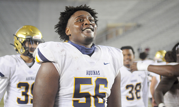 Senior lineman Marco Fugar (56) looks at the scoreboard as he celebrates St. Thomas Aquinas' 31-21 victory over Orlando Edgewater, Dec. 19, 2020, in the FHSAA Class 7A Football State Championship Game at Bobby Bowden Field at Doak Campbell Stadium. The Raiders won their state-record 12th title.