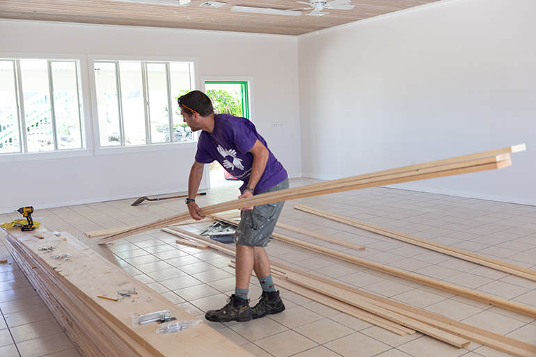 International volunteers make preliminary repairs last February at St. Francis de Sales School in Abaco, which was closed following last year's devastating Category 5 Hurricane Dorian.