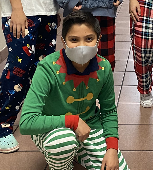Christian San Juan, an eighth grader at Our Lady of Lourdes Academy in Miami, dressed as an elf to help distribute toys collected by the school for children of immigrant workers at Las Hormiguitas del Senor (God's Little Ants) in the Redland.