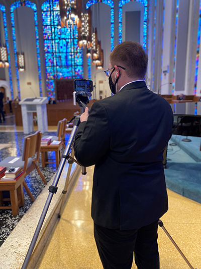 Seminarian Peter Jutras adjusts the camera prior to the livestreaming of Mass at St. Vincent de Paul Regional Seminary in Boynton Beach.