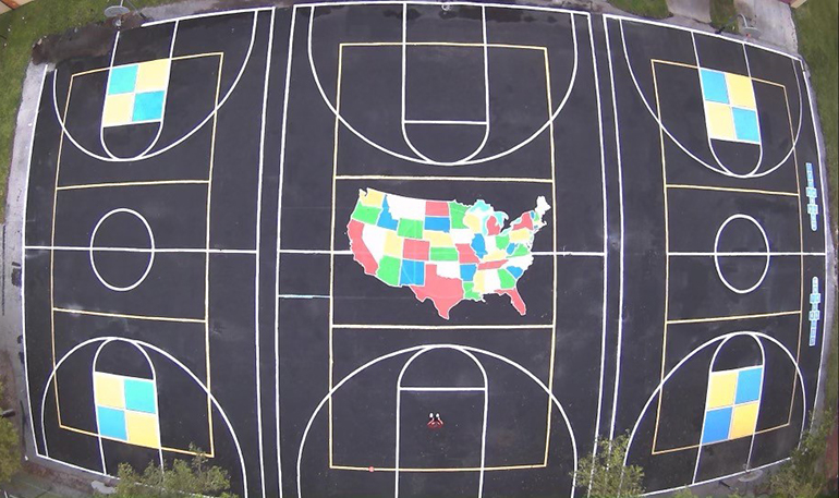 View from above of the colorful new basketball and box ball courts created by Columbus High senior William Dunkley, Jr., at the school he attended as a child, Our Lady of the Lakes in Miami Lakes.