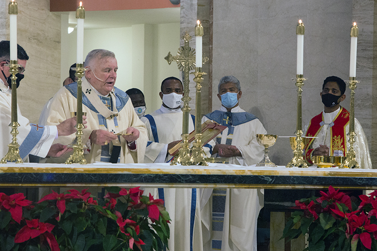 Archbishop Thomas Wenski celebrates the annual Migration Mass on the feast of the Epiphany, Jan. 3, 2021. Also taking part are transitional Deacon Franklyn Ekezie of Nigeria, FatherJesus "Jets" Medina, a native of the Philippines, administrator of St. Peter in Big Pine Key and director of the Ministry to Cultural Groups, and Father Thomas Pulickal of India, assistant vicar at Our Lady of Health Syro-Malabar Catholic Church in Coral Springs.