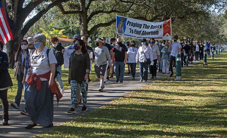 Blessed Trinity parishioners and others take part in a Prayer Walk For Life along Curtiss Parkway in Miami Springs, Jan. 23, 2021.