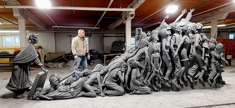 Sculptor Timothy Schmalz looks over his next sculpture, "Let the Oppressed Go Free." The figure at left is St. Josephine Bakhita, patron saint of human trafficking.