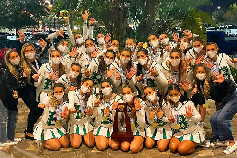 St. Brendan cheerleaders pose with their coaches and trophy for their sixth consecutive state championship, won Jan. 23, 2021. They now have their sight set on the Universal Cheerleading Association's High School Nationals, set for April 23-25 at World Disney World.