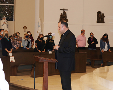 Father Israel Mago, pastor of Our Lady of Guadalupe Church in Doral, prays with parishioners at the start of the informational session on Deferred Enforced Departure for Certain Venezuelans, which took place Jan. 27, 2021.