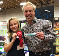 Dentist and mentor David Zadik stopped by Nikita Marino's booth at her school science fair in Greenwich Catholic School in Connecticut, where she received second place for her invention of Bite Bright.