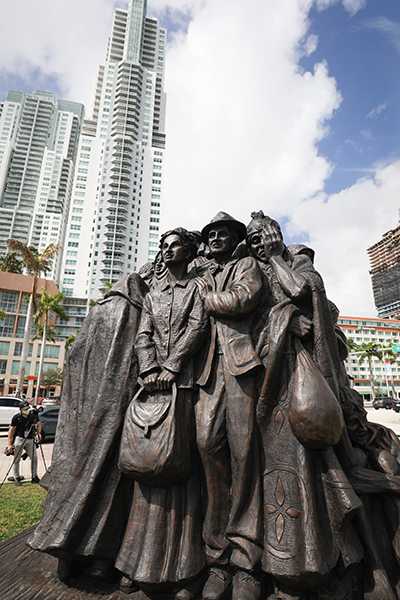 The Angels Unawares sculpture sits in a corner of Bayfront Park, surrounded by the tall buildings of downtown Miami Feb. 10, 2021. The sculpture, a tribute to migrants and refugees, will remain at the park through April 8, 2021.