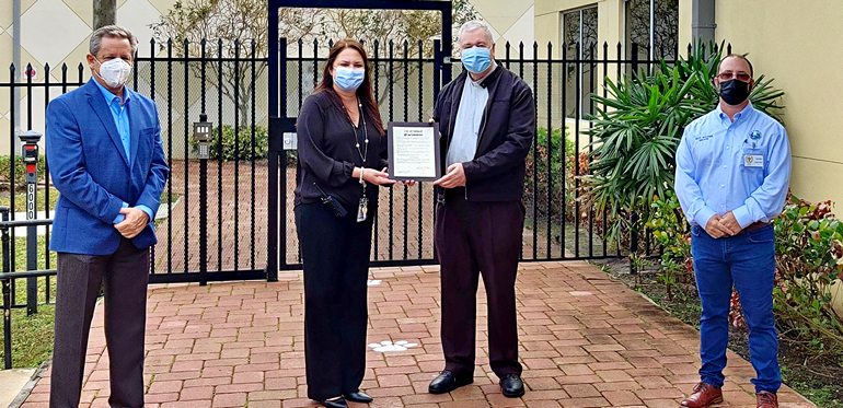 School and city officials in Parkland show the recent proclamation for Mary Help of Christians School in honor of Catholic Schools Week. Pictured from left to right are Vice-Mayor Bob Mayersohn of Parkland; Principal Alexandra Fernandez of the school; Msgr. Terence Hogan, pastor of the church; and Mayor Rich Walker.