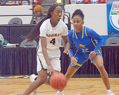 St. Thomas Aquinas' Karina Gordon (4) drives past Charlotte's Aryana Hicks during the second half of St. Thomas Aquinas' 62-48 victory over Punta Gorda Charlotte on Thursday, Feb. 26, 2021, in the FHSAA Class 6A girls basketball state semifinals at the RP Funding Center in Lakeland. Gordon had 24 points and nine rebounds.