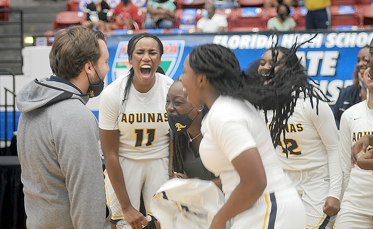 St. Thomas Aquinas coach Oliver Berens fires up his team in celebration after their 62-60 victory over Wekiva in the FHSAA Class 6A girls basketball championship game Saturday, Feb. 27, 2021, at the RP Funding Center in Lakeland. The Raiders won their first championship.