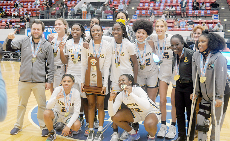 St. Thomas Aquinas players and coaches celebrate with the championship trophy after their 62-60 victory over Wekiva in the FHSAA Class 6A girls basketball championship game Saturday, Feb. 27, 2021, at the RP Funding Center in Lakeland. The Raiders won their first championship.