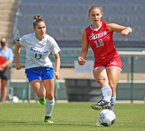 Cardinal Gibbons junior Sydney Polivka, right, passes away from Arnold's Olivia Lebdaoui during the first half of Cardinal Gibbons' 2-0 victory over Panama City Beach Arnold in the FHSAA Class 4A girls soccer championship game March 3, 2021, at Spec Martin Stadium in DeLand. Polivka scored a goal, and the Chiefs won their first girls soccer championship.