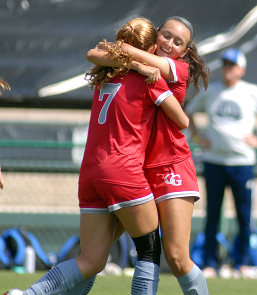 Cardinal Gibbons freshmen Samantha Fuini and Julianna Torres (7) celebrate Fuini's goal in the first half of Cardinal Gibbons' 2-0 victory over Panama City Beach Arnold in the FHSAA Class 4A girls soccer championship game March 3, 2021, at Spec Martin Stadium in DeLand. The Chiefs won their first girls soccer championship.