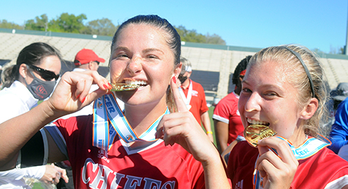 Senior Heather Astle, left, and junior Erin Pawelczyk perform the bite test on their gold medals while celebrating Cardinal Gibbons' 2-0 victory over Panama City Beach Arnold in the FHSAA Class 4A girls soccer championship game March 3, 2021, at Spec Martin Stadium in DeLand. The Chiefs won their first girls soccer championship.