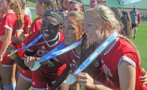 From left, Senior Deborah Bien-Aime, senior Madison Rivard and junior Erin Pawelczyk show off their gold medals after Cardinal Gibbons' 2-0 victory over Panama City Beach Arnold in the FHSAA Class 4A girls soccer championship game March 3, 2021, at Spec Martin Stadium in DeLand. The Chiefs won their first girls soccer championship.