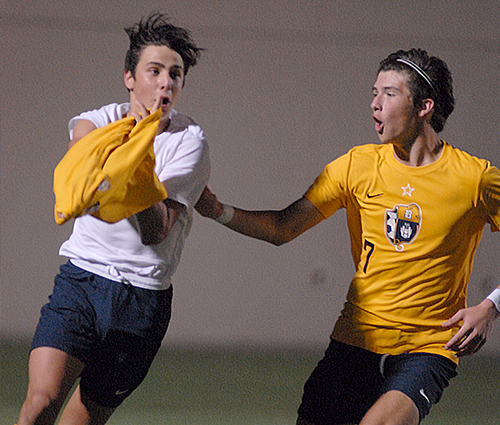 Stefano Naos, left, and Christian Bargueiras (7) celebrate Naos' goal during the second overtime of the Belen Jesuit Wolverines' 2-1 overtime victory over the Tampa Jesuit Tigers, March 6, 2021 in the FHSAA Class 5A Boys Soccer Championship Game at Spec Martin Stadium in DeLand. The goal put Belen Jesuit ahead and helped the Wolverines deny seven-time champ Tampa Jesuit a repeat Class 5A title.