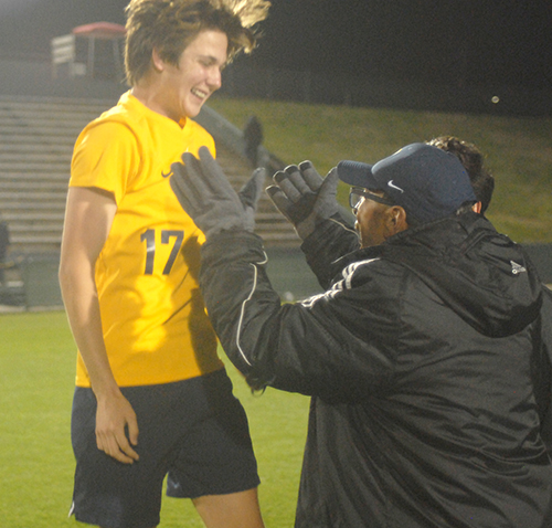 Belen Jesuit sophomore Lucas Monge (17) leaps into the arms of Wolverines head coach Tanger Mendonca after their 2-1 overtime victory over the Tampa Jesuit Tigers, March 6, 2021 in the FHSAA Class 5A Boys Soccer Championship Game at Spec Martin Stadium in DeLand.