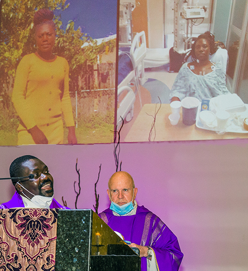 Father Joseph Jean-Louis, Sacred Heart parochial vicar, thanks Jackson Memorial Hospital's International Kids Foundation Wonderfund, which brought his niece to Miami from Haiti for a delicate heart surgery, as Father Federico Capdepon looks on, during a Mass celebrated Feb. 28, 2021 at Corpus Christi Church in Miami.