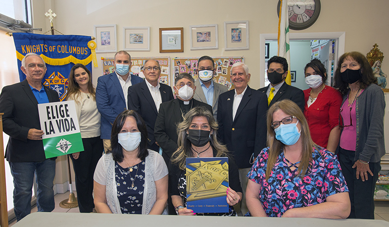 Auxiliary Bishop Enrique Delgado, St. Katharine Drexel Church Knights of Columbus, and respect life staff and volunteers pose for a photo after the bishop dedicated the new ultrasound machine at the North Broward Pregnancy Help Center in Margate, March 3, 2021.