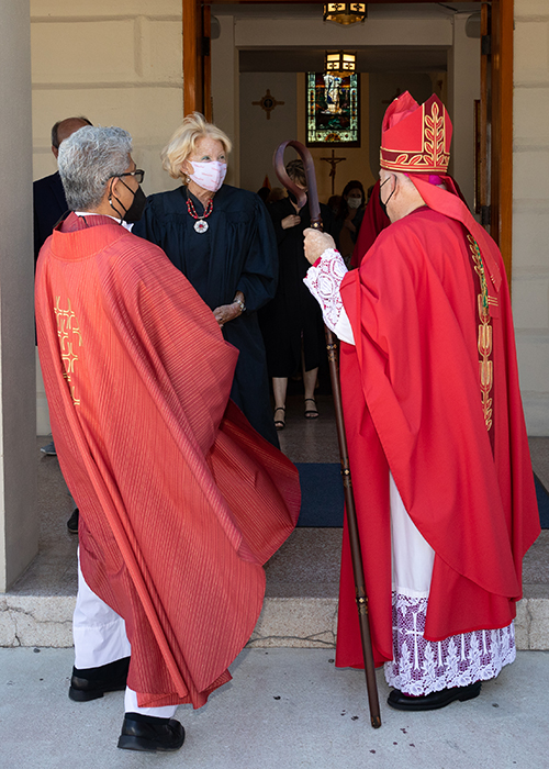 Miami Archbishop Thomas Wenski, who celebrated the annual Red Mass for Monroe County March 5, 2021 at the Basilica of St. Mary Star of the Sea, greets regional lawyers, judges, public officials and other law professionals following the Mass. At left is Father Jets Medina, administrator of St. Peter Parish in Big Pine Key, who concelebrated the Mass.