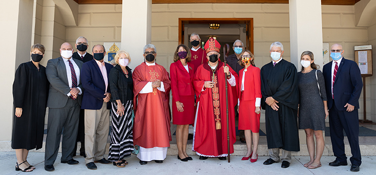 Miami Archbishop Thomas Wenski, who celebrated the annual Red Mass for Monroe County March 5, 2021 at the Basilica of St. Mary Star of the Sea, poses for a group photo with regional lawyers, judges, public officials and other law professionals following the Mass.