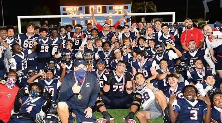 Christopher Columbus High School's football players and coaches celebrate after winning the Tri-County championship in the 8A Gold Division in December 2020. Columbus decided to participate in the newly created championship, rather than the state's FHSAA playoffs, due to the loss of practice and playing time caused by school shutdowns during due to the coronavirus pandemic. The team won the 8A FHSAA state championship in 2019.