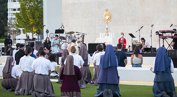 Over 200 attendees including members of the Servants of the Pierced Hearts of Jesus and Mary and members of the Daughters of St. Paul, participate in a moment of adoration during the EPIC Night of Mercy event celebrated at St. Thomas University in Miami Gardens, April 10, 2021.