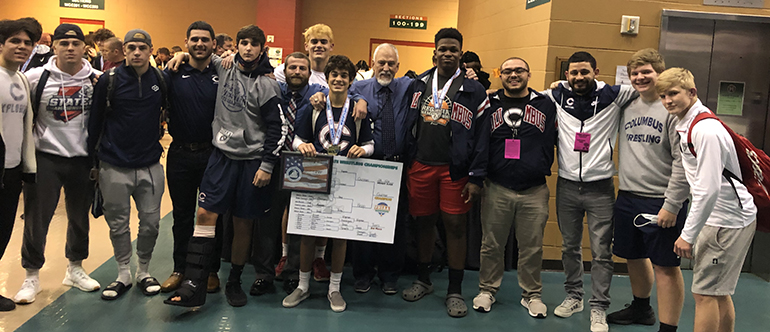 Columbus state wrestling champion Christian Guzman is pictured here with teammates and coaches after the state championship final in Kissimmee in March 2021.